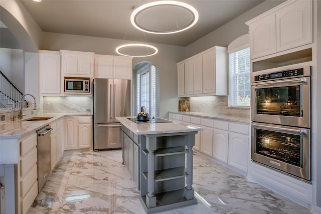 6513 Crawley Dr, Plano, TX 75093 - kitchen featuring stainless steel appliances, open shelves, arched walkways, a sink, and light stone countertops