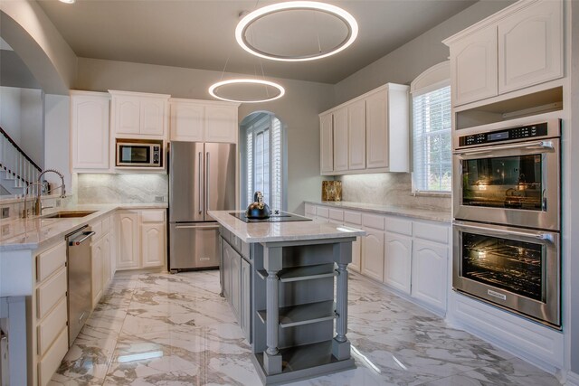 6513 Crawley Dr, Plano, TX 75093 - kitchen featuring stainless steel appliances, open shelves, arched walkways, a sink, and light stone countertops