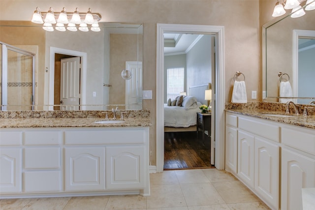6513 Crawley Dr, Plano, TX 75093 - bathroom featuring crown molding, a shower stall, tile patterned flooring, two vanities, and ensuite bathroom