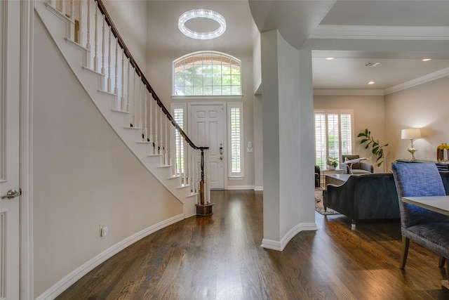 6513 Crawley Dr, Plano, TX 75093 - foyer with wood finished floors, stairs, baseboards, and crown molding