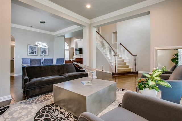 6513 Crawley Dr, Plano, TX 75093 - living area featuring stairway, wood finished floors, a chandelier, baseboards, and crown molding