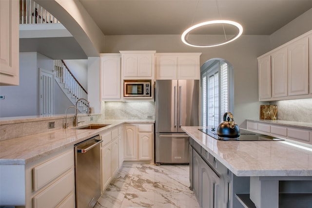 6513 Crawley Dr, Plano, TX 75093 - kitchen with stainless steel appliances, a sink, light marble finish floors, and light stone counters