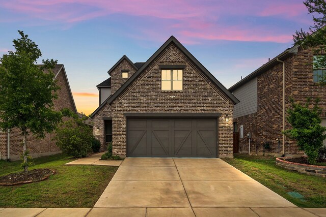 4533 Wilbarger St, Plano, TX 75024 - view of front of house featuring a front yard, a garage, brick siding, and driveway