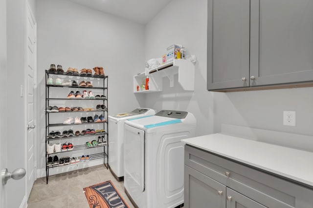 4533 Wilbarger St, Plano, TX 75024 - laundry area featuring separate washer and dryer, cabinet space, and light tile patterned floors