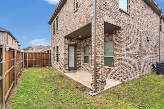 4533 Wilbarger St, Plano, TX 75024 - rear view of house featuring brick siding, central air condition unit, and a patio