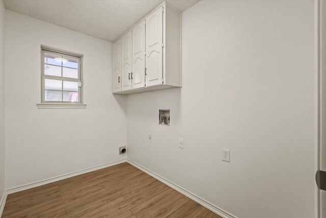 clothes washing area featuring washer hookup, cabinet space, baseboards, light wood finished floors, and hookup for an electric dryer