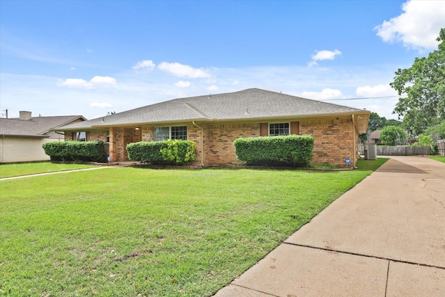 view of front of property featuring brick siding, concrete driveway, and a shingled roof