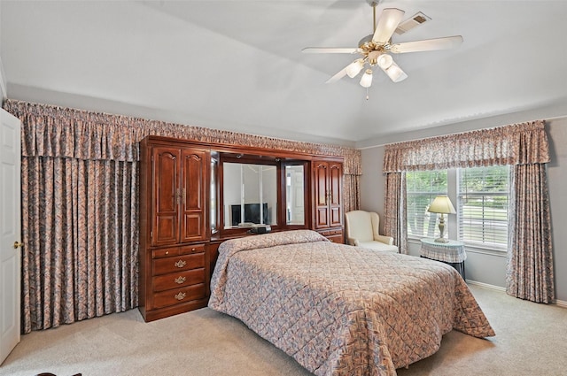 bedroom featuring light carpet, baseboards, and ceiling fan