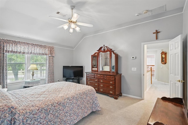carpeted bedroom featuring lofted ceiling, baseboards, and a ceiling fan