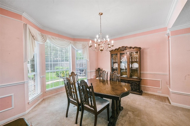 dining room featuring a chandelier, crown molding, and light carpet