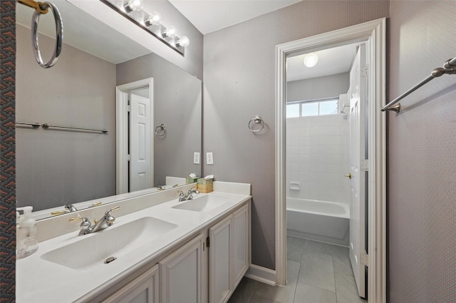 full bathroom with double vanity, baseboards, tile patterned flooring, and bathing tub / shower combination