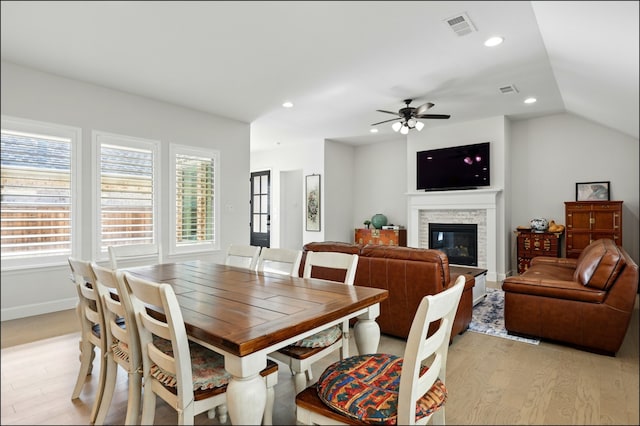 8529 Melrose, The Colony, TX 75056 - dining space featuring light wood-style floors, a stone fireplace, recessed lighting, ceiling fan, and lofted ceiling