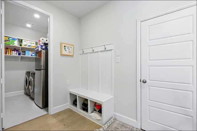 8529 Melrose, The Colony, TX 75056 - mudroom featuring independent washer and dryer, baseboards, and light wood-style flooring