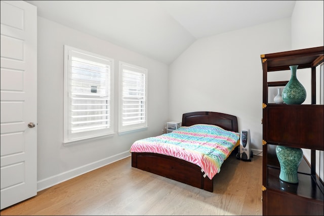 8529 Melrose, The Colony, TX 75056 - bedroom featuring wood finished floors, multiple windows, vaulted ceiling, and baseboards