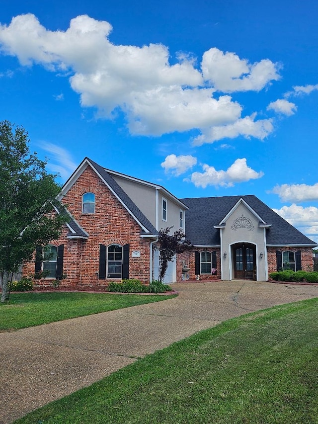 725 Saint Martins Ln, Bossier City, LA 71111 - traditional-style house featuring french doors, a garage, brick siding, and concrete driveway