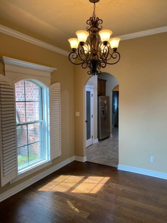 725 Saint Martins Ln, Bossier City, LA 71111 - unfurnished dining area featuring arched walkways, a chandelier, wood finished floors, plenty of natural light, and ornamental molding