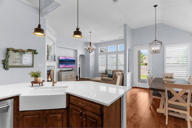 700 Renault Way, Mckinney, TX 75071 - kitchen with a sink, stainless steel dishwasher, a chandelier, arched walkways, and wood finished floors