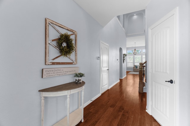 700 Renault Way, Mckinney, TX 75071 - corridor with dark wood-style floors, a chandelier, baseboards, and arched walkways