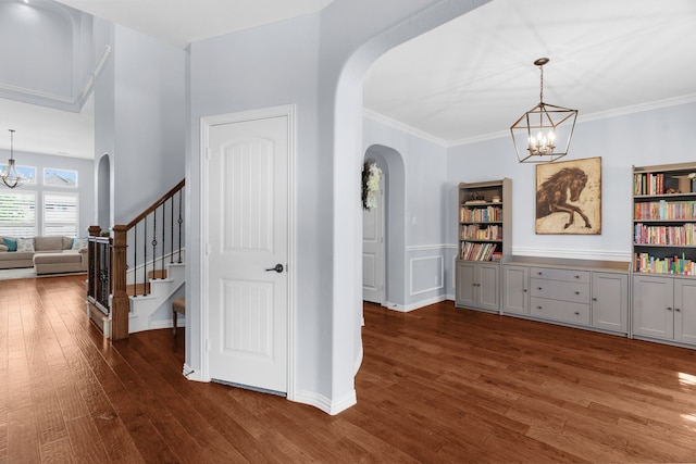 700 Renault Way, Mckinney, TX 75071 - entrance foyer with a chandelier, arched walkways, dark wood-type flooring, stairs, and crown molding