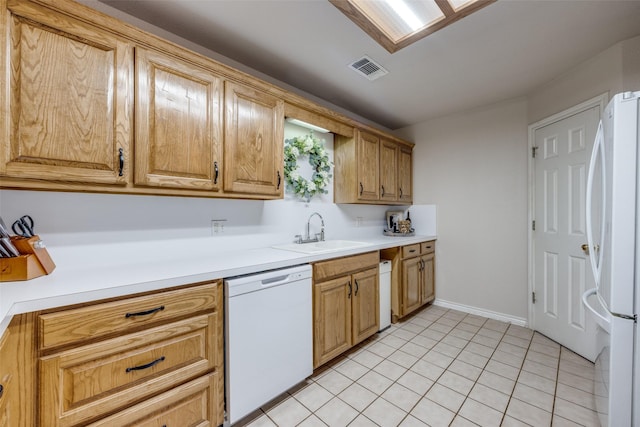 4942 US Highway 69, Denison, TX 75021 - kitchen with a sink, white appliances, light countertops, and light tile patterned flooring