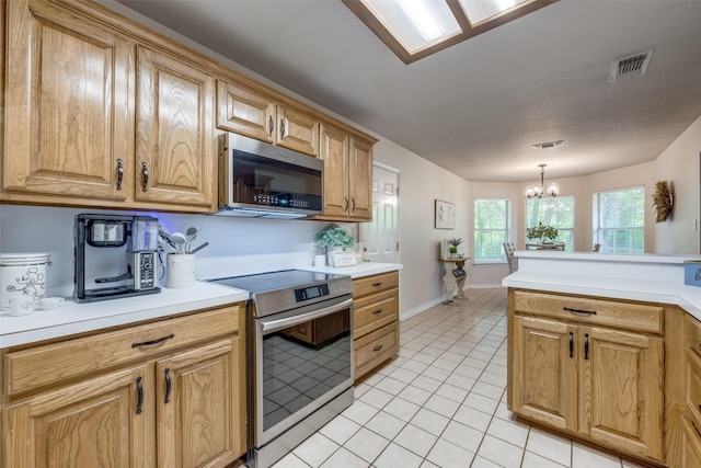 4942 US Highway 69, Denison, TX 75021 - kitchen with stainless steel appliances, a chandelier, light tile patterned floors, and light countertops