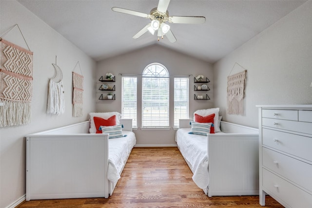 4942 US Highway 69, Denison, TX 75021 - bedroom featuring light wood-type flooring, lofted ceiling, a ceiling fan, and baseboards