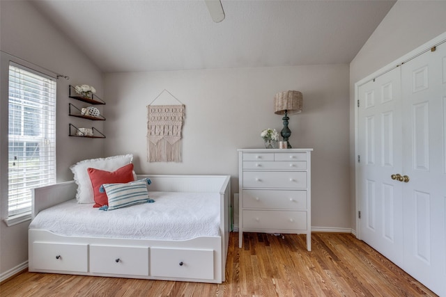 4942 US Highway 69, Denison, TX 75021 - bedroom with wood finished floors, baseboards, lofted ceiling, and a closet