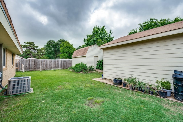 view of yard with central air condition unit and an outbuilding