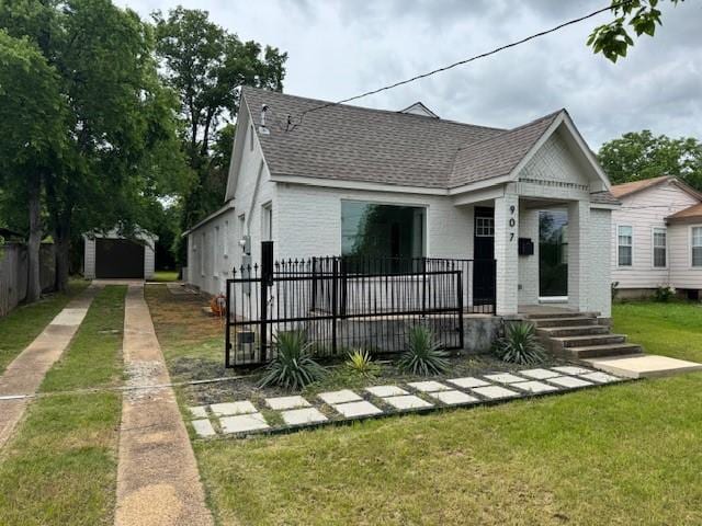 view of front of property with roof with shingles and brick siding