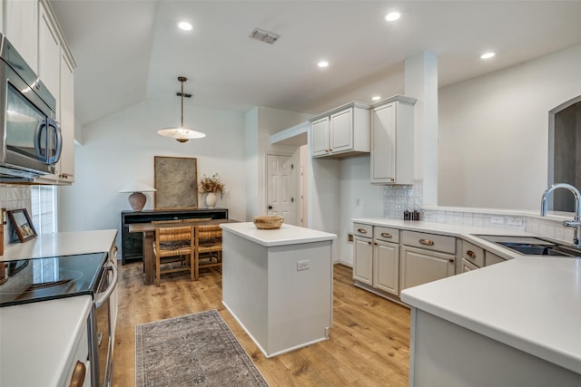 6520 Creek Crossing Ln, Sachse, TX 75048 - kitchen with a sink, appliances with stainless steel finishes, decorative backsplash, decorative light fixtures, and light wood finished floors