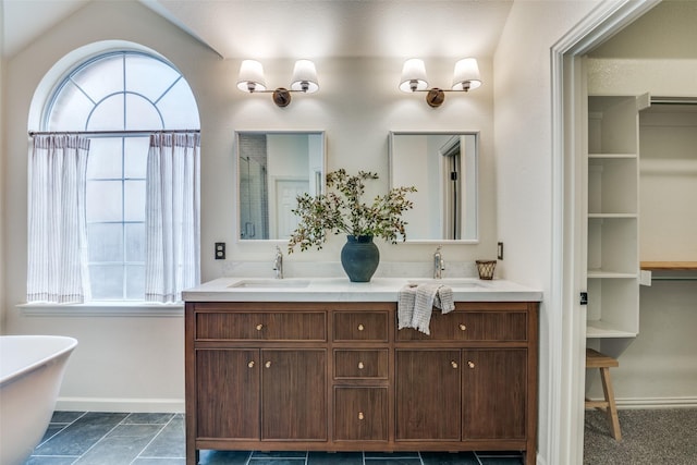 6520 Creek Crossing Ln, Sachse, TX 75048 - bathroom with healthy amount of natural light, baseboards, double vanity, and a soaking tub