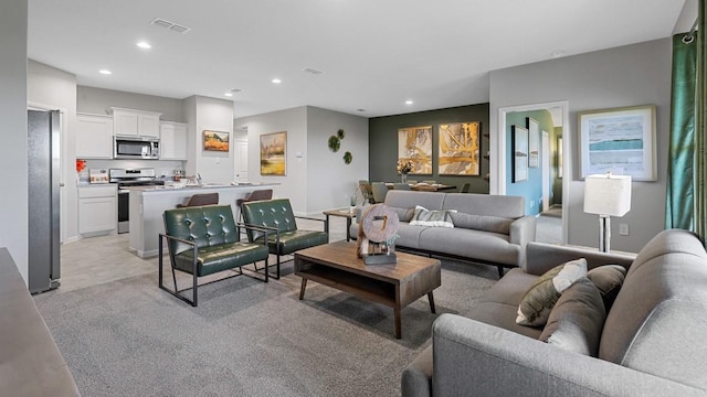 1612 Cansler Dr, Denton, TX 76249 - living room with recessed lighting, baseboards, and light colored carpet