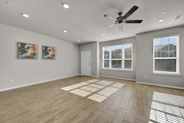 2867 Baneberry Ln, Mesquite, TX 75150 - empty room with light wood finished floors, baseboards, a ceiling fan, and recessed lighting