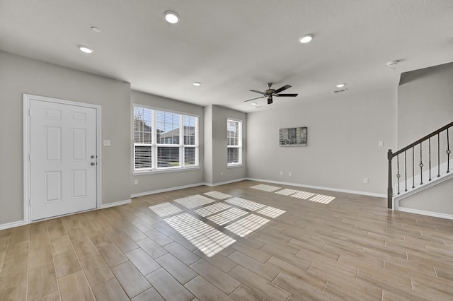 2867 Baneberry Ln, Mesquite, TX 75150 - unfurnished living room with light wood finished floors, ceiling fan, recessed lighting, stairs, and baseboards