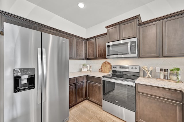 2867 Baneberry Ln, Mesquite, TX 75150 - kitchen with stainless steel refrigerator with ice dispenser, dark brown cabinetry, a sink, light countertops, and baseboards