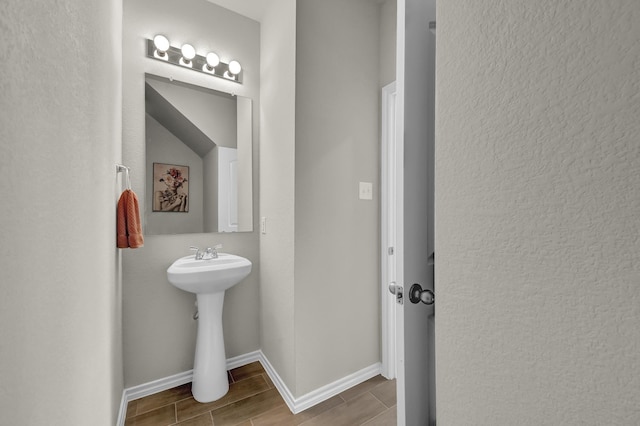 2867 Baneberry Ln, Mesquite, TX 75150 - bathroom with wood tiled floors, baseboards, and a sink