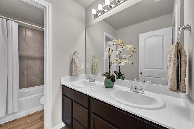 2867 Baneberry Ln, Mesquite, TX 75150 - bathroom featuring double vanity, toilet, shower / bath combination with curtain, and wood finished floors