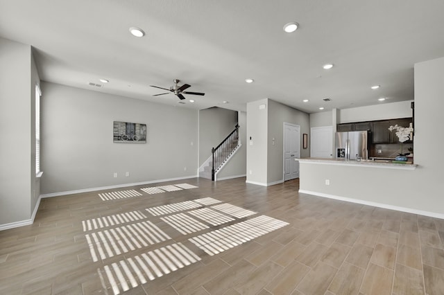 2867 Baneberry Ln, Mesquite, TX 75150 - unfurnished living room featuring recessed lighting, stairway, a ceiling fan, baseboards, and light wood-style floors