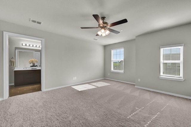 2867 Baneberry Ln, Mesquite, TX 75150 - unfurnished bedroom featuring carpet, baseboards, ensuite bath, and ceiling fan