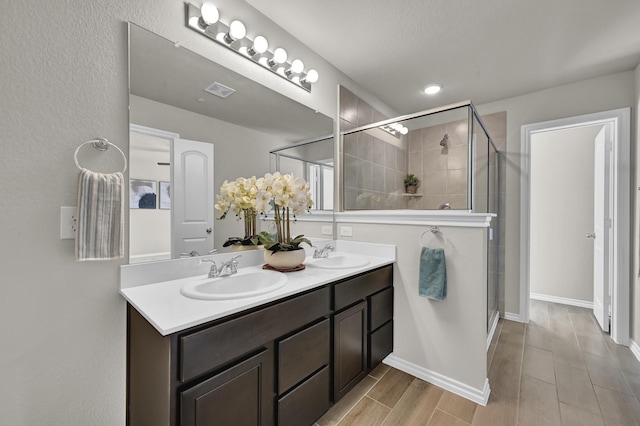 2867 Baneberry Ln, Mesquite, TX 75150 - full bathroom with a stall shower, double vanity, and baseboards