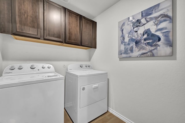 2867 Baneberry Ln, Mesquite, TX 75150 - clothes washing area with cabinet space, washer and dryer, baseboards, and light wood finished floors