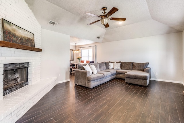 2802 Rio Grande Pass, Mesquite, TX 75150 - living area featuring a brick fireplace, baseboards, ceiling fan, a textured ceiling, and lofted ceiling