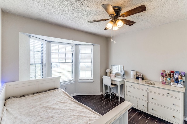 2802 Rio Grande Pass, Mesquite, TX 75150 - bedroom with wood tiled floors, a textured ceiling, baseboards, and a ceiling fan