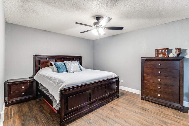 2802 Rio Grande Pass, Mesquite, TX 75150 - bedroom featuring wood finished floors, baseboards, a textured ceiling, and ceiling fan