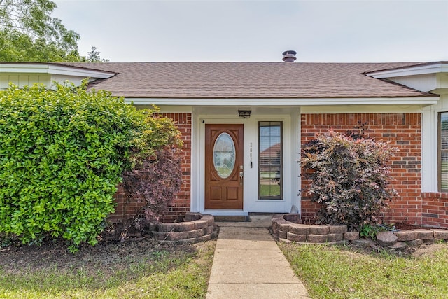 2802 Rio Grande Pass, Mesquite, TX 75150 - view of exterior entry featuring roof with shingles and brick siding