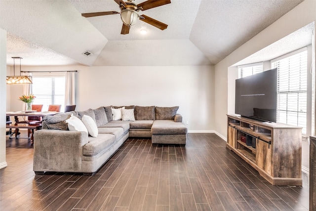 2802 Rio Grande Pass, Mesquite, TX 75150 - living area with a ceiling fan, dark wood finished floors, baseboards, a textured ceiling, and vaulted ceiling