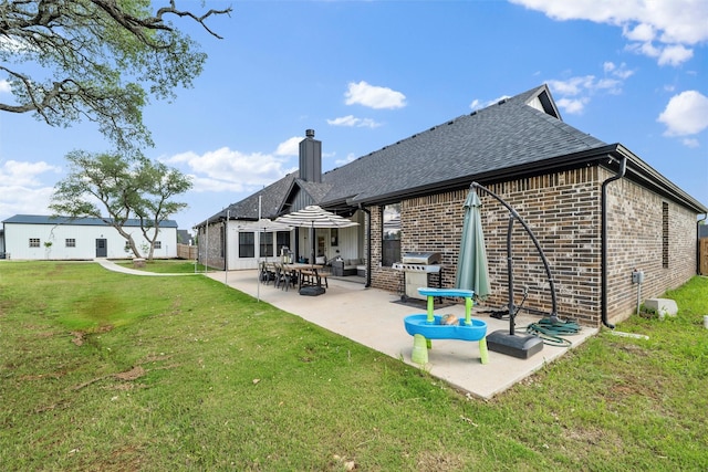 260 Greene Rd, Weatherford, TX 76087 - back of property featuring brick siding, a yard, a patio area, and a shingled roof