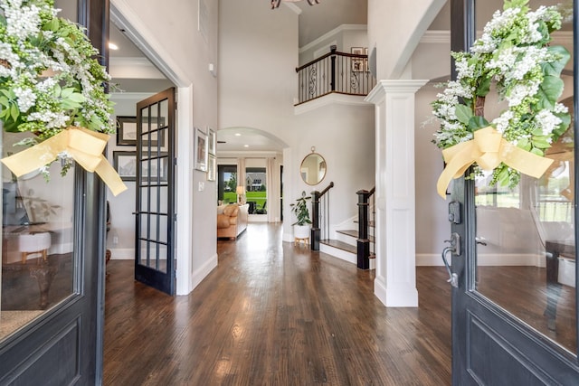 5 Maltese Cir, Heath, TX 75032 - entrance foyer featuring stairs, dark wood-style floors, ornamental molding, baseboards, and arched walkways