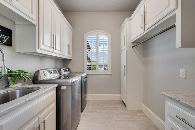 5 Maltese Cir, Heath, TX 75032 - laundry area featuring washing machine and clothes dryer, baseboards, and cabinet space