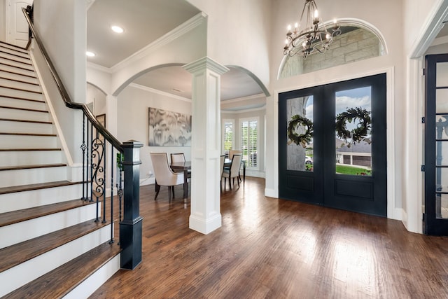 5 Maltese Cir, Heath, TX 75032 - foyer entrance with arched walkways, wood finished floors, crown molding, stairway, and a chandelier
